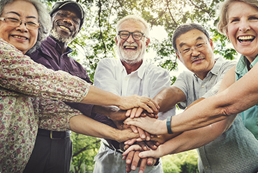 group of people stacking hands